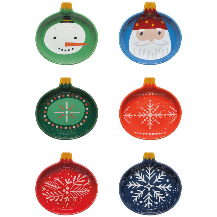 Set of six colorful ceramic Christmas ornaments with snowflake and Santa designs on a white background.