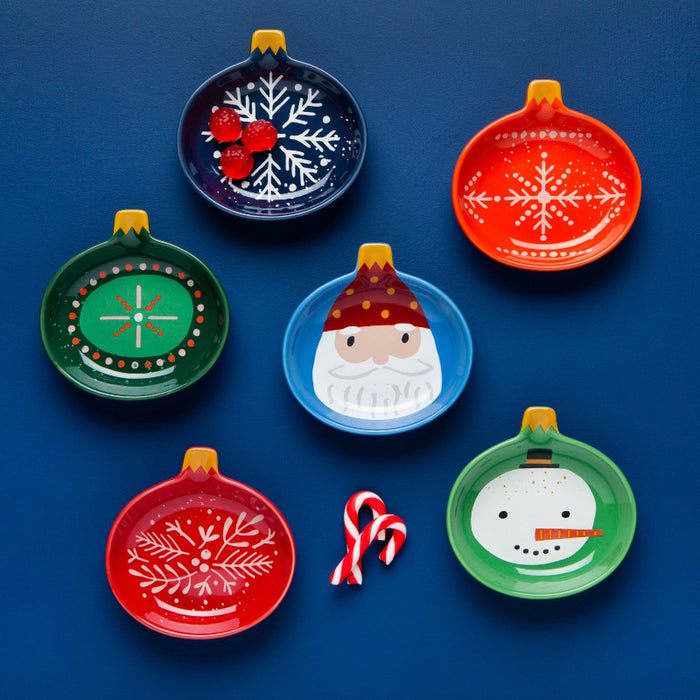 Set of colorful Christmas-themed plates on a blue background