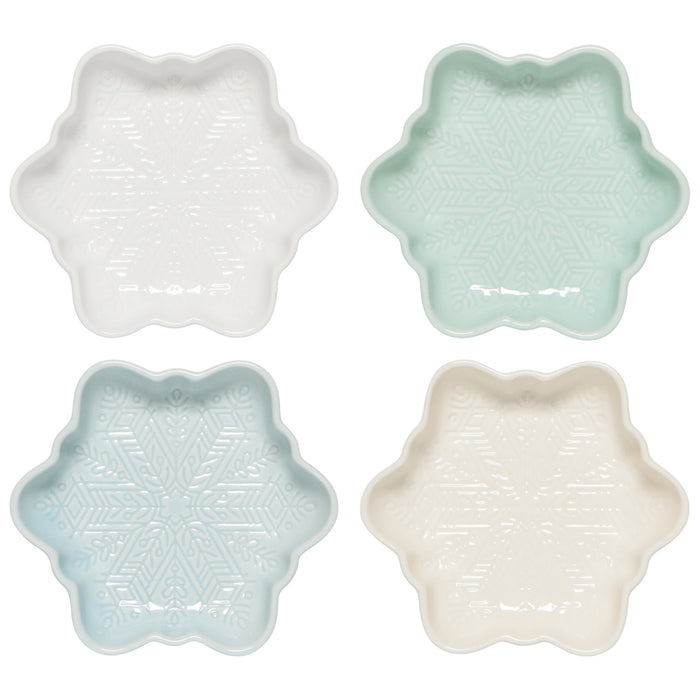 Four star-shaped ceramic dishes in white, light blue, and beige on a white background