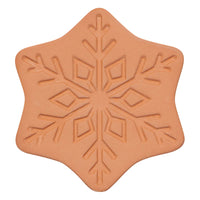 Star-shaped cookie cutter with snowflake design on a white background